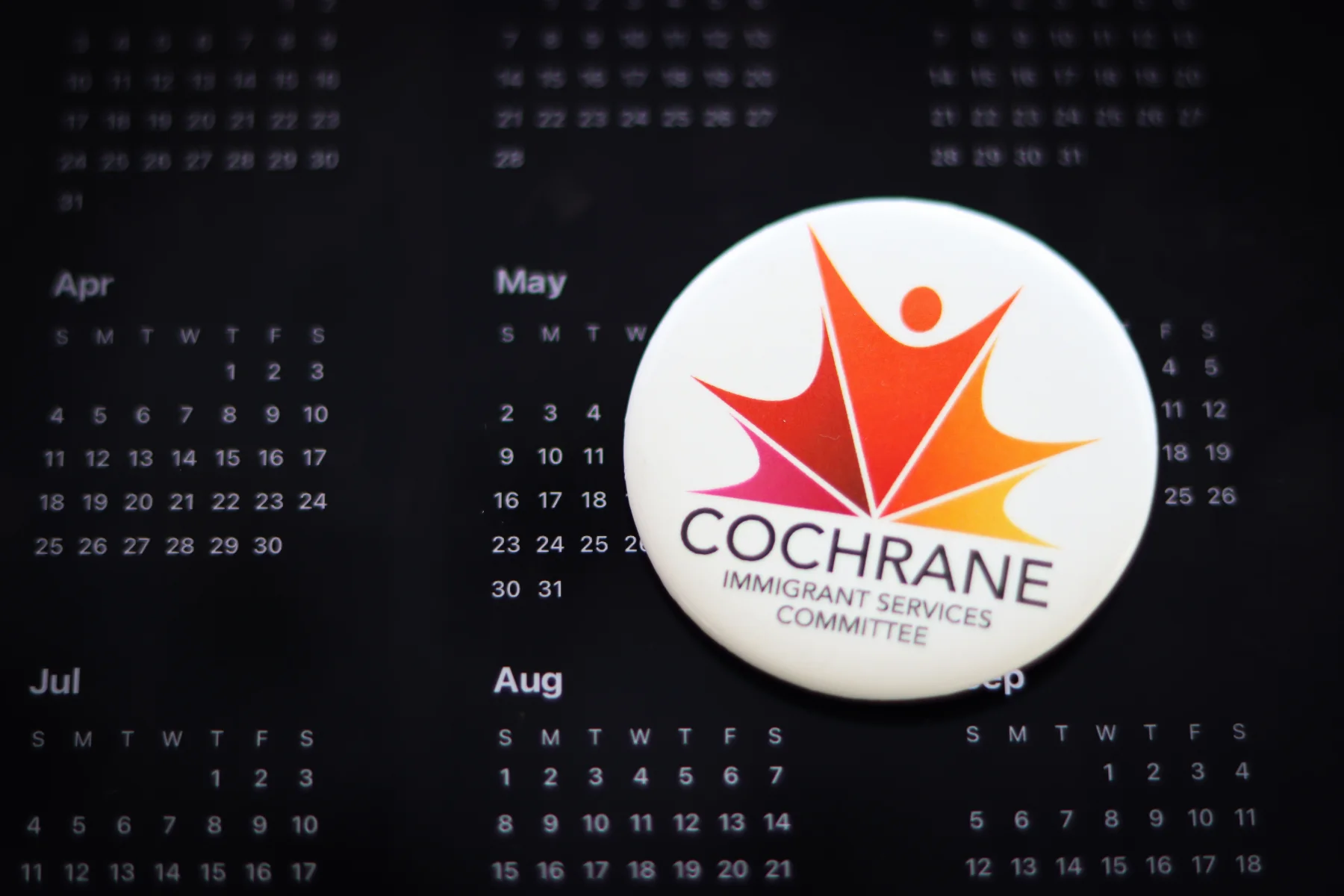 CISC button resting on a calendar